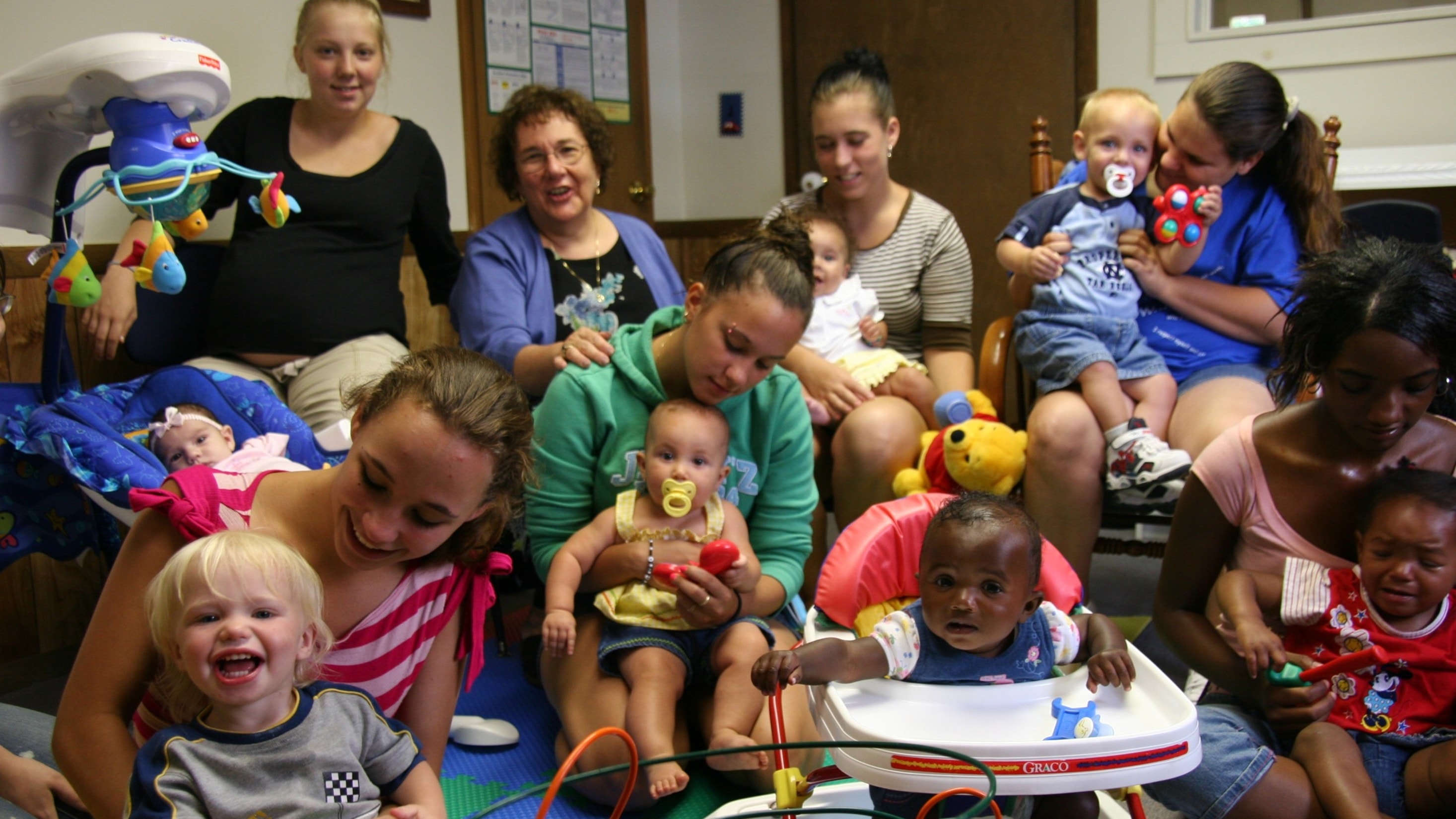 Young parents and children participating in a teen parenting program